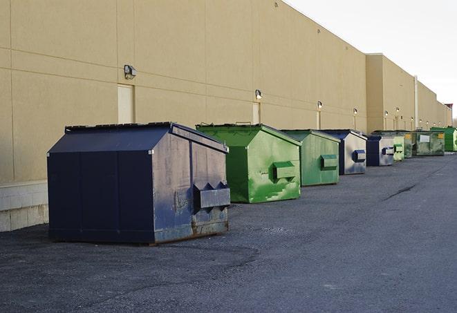 a row of blue construction dumpsters on a job site in Asbury IA